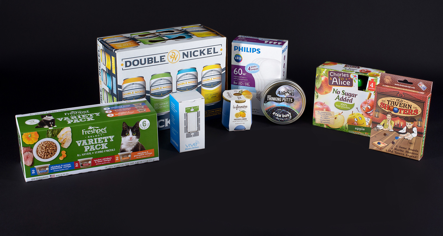 Consumer packaging shown for cat food, yogurt, games, applesauce